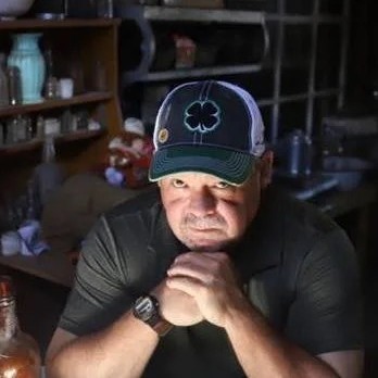 Chris Fisk, paranormal investigator, seated inside the Dumas