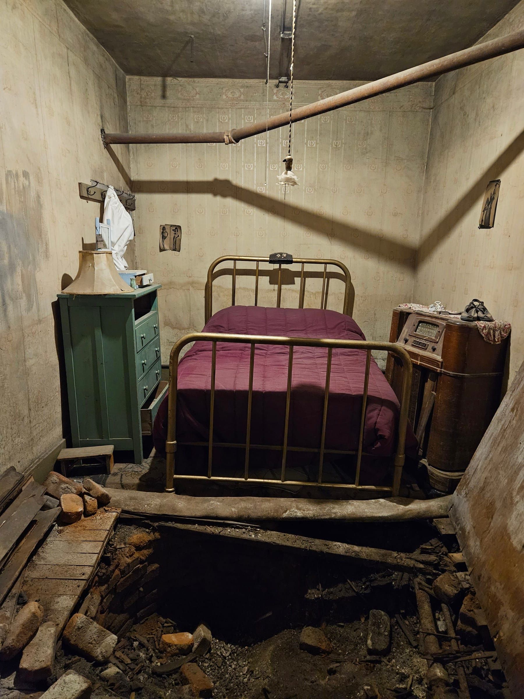 A Dumas crib room with brass bed and maroon spread